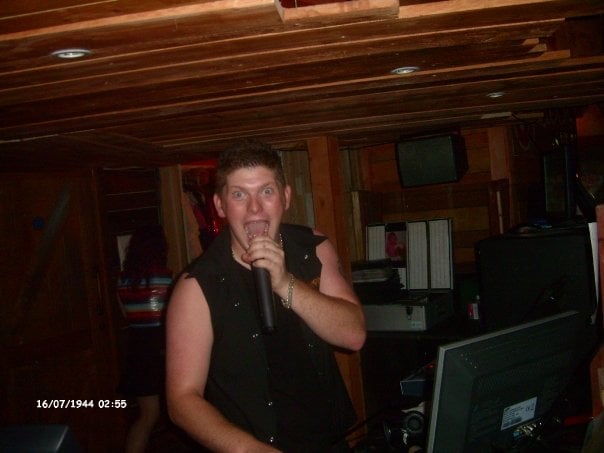 Jon mid-shout on the microphone in a bar