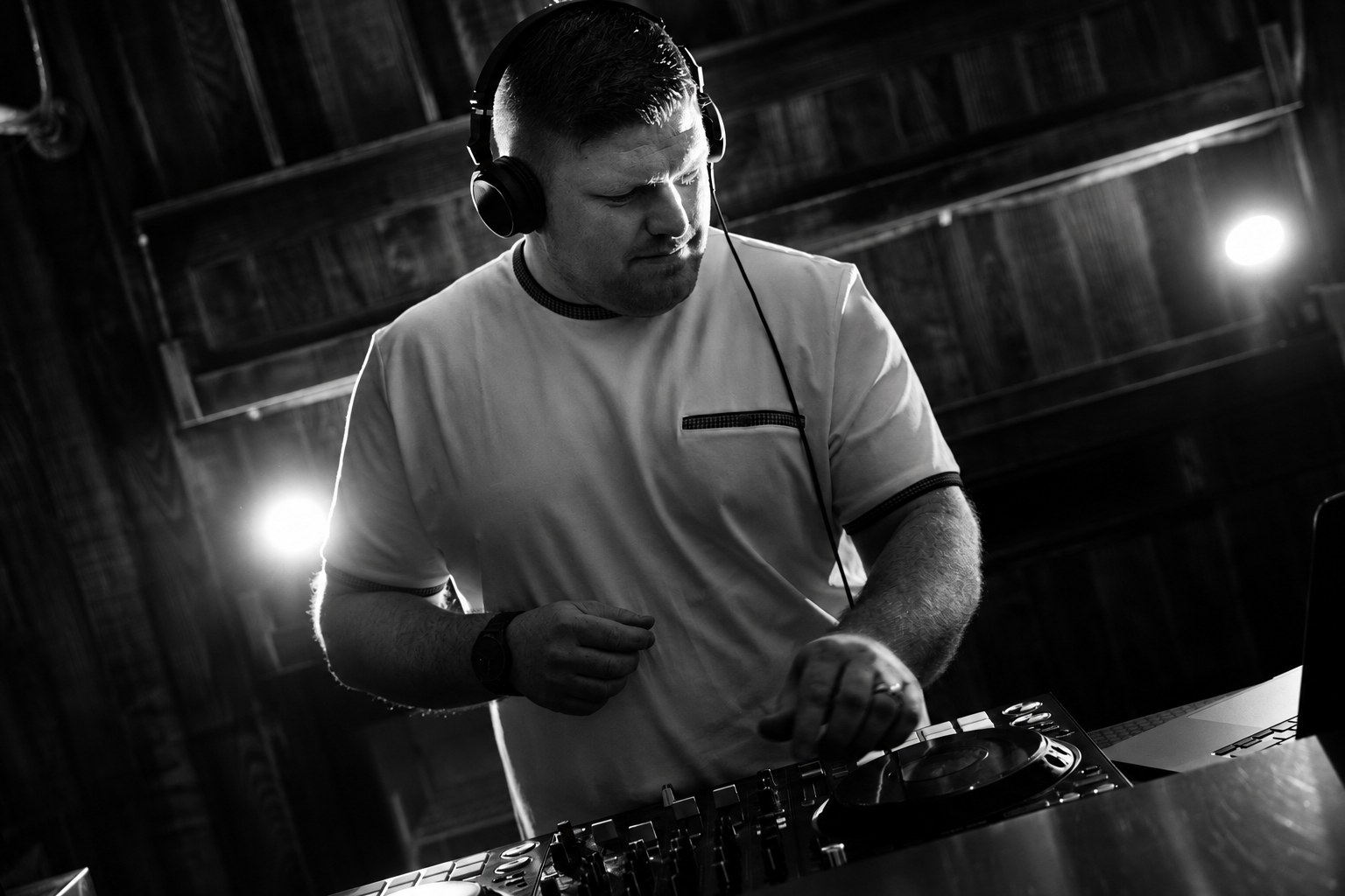 Jon DJing in headphones, black and white