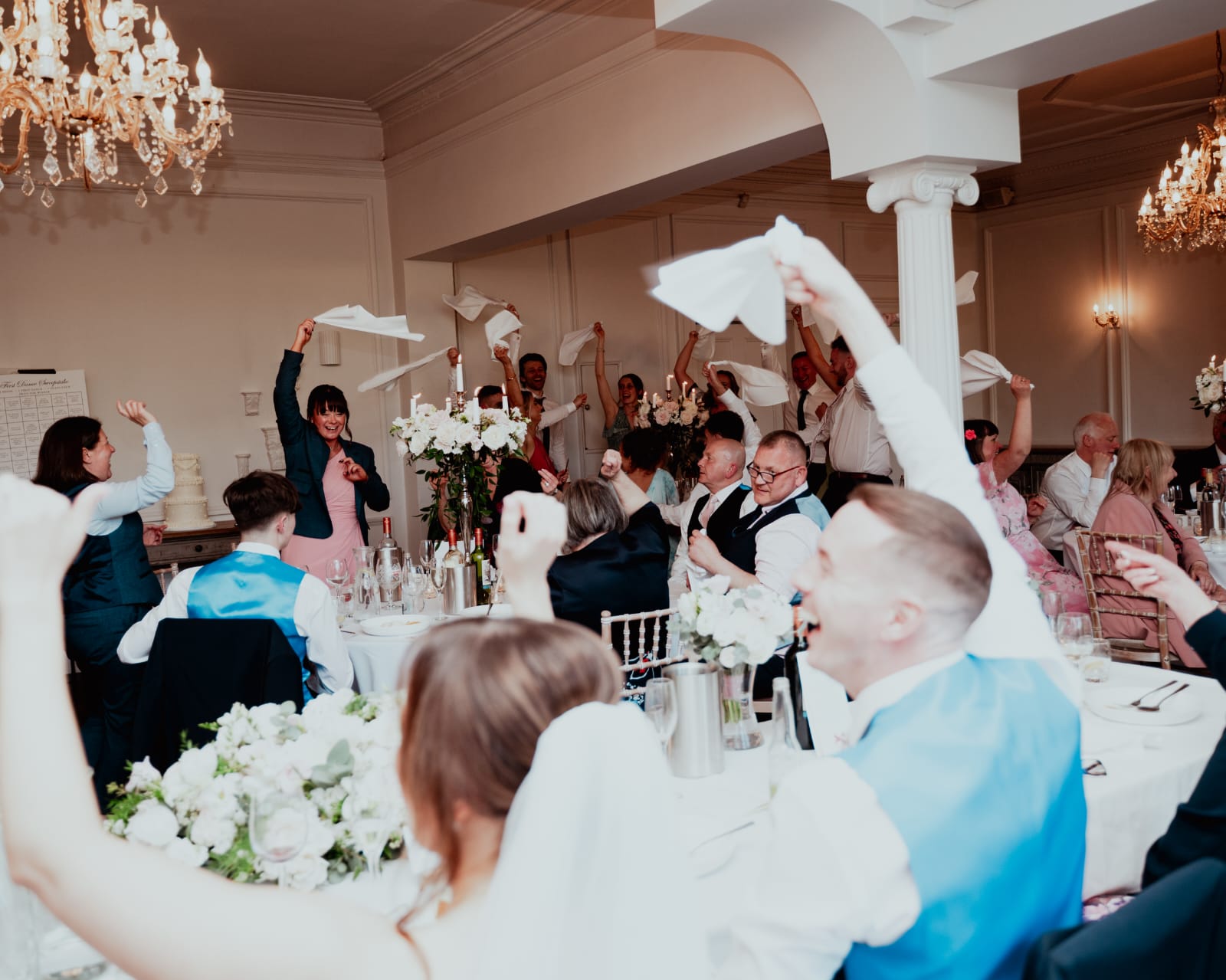 Guests waving napkins during the wedding breakfast