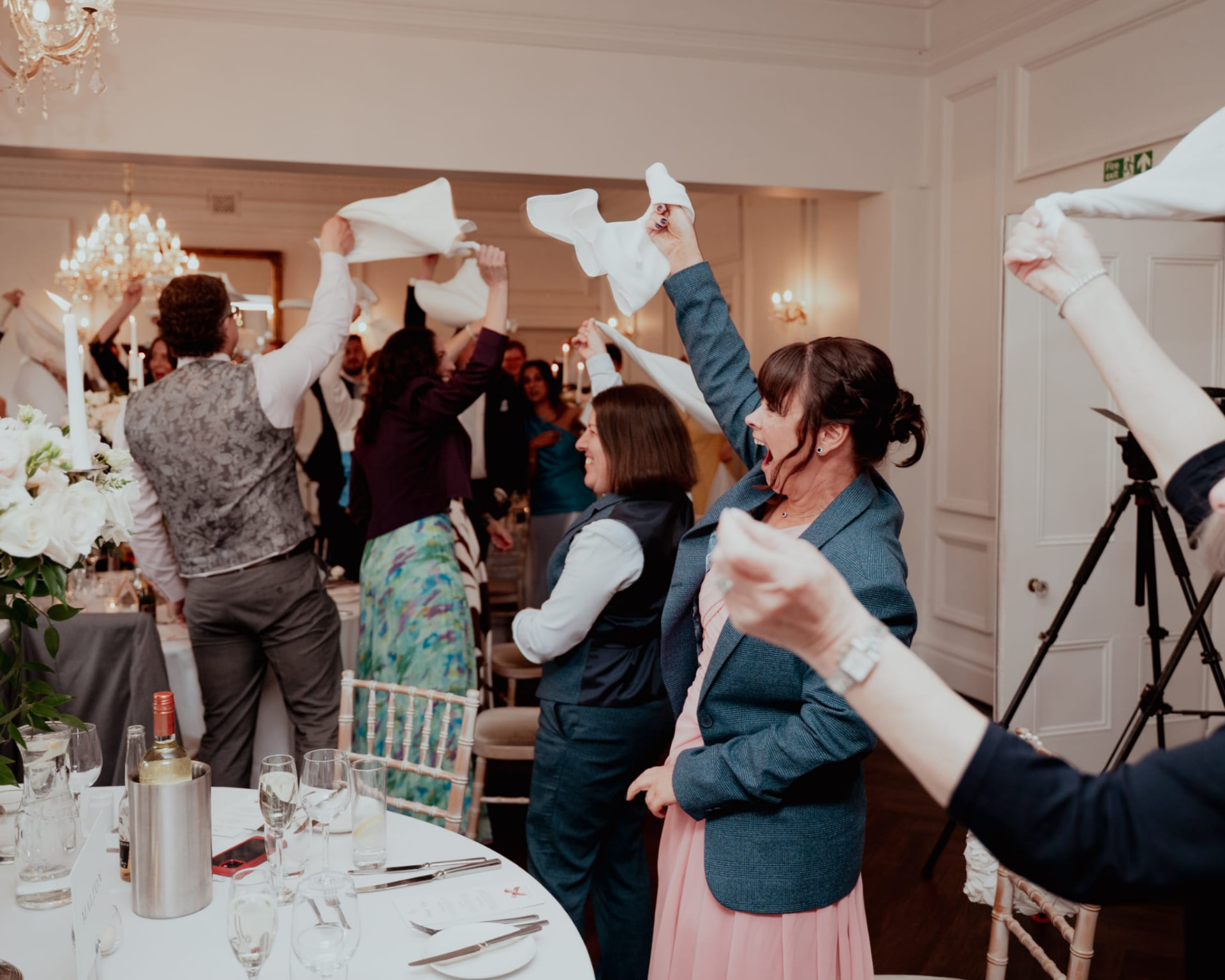 Guests standing and waving napkins between the tables