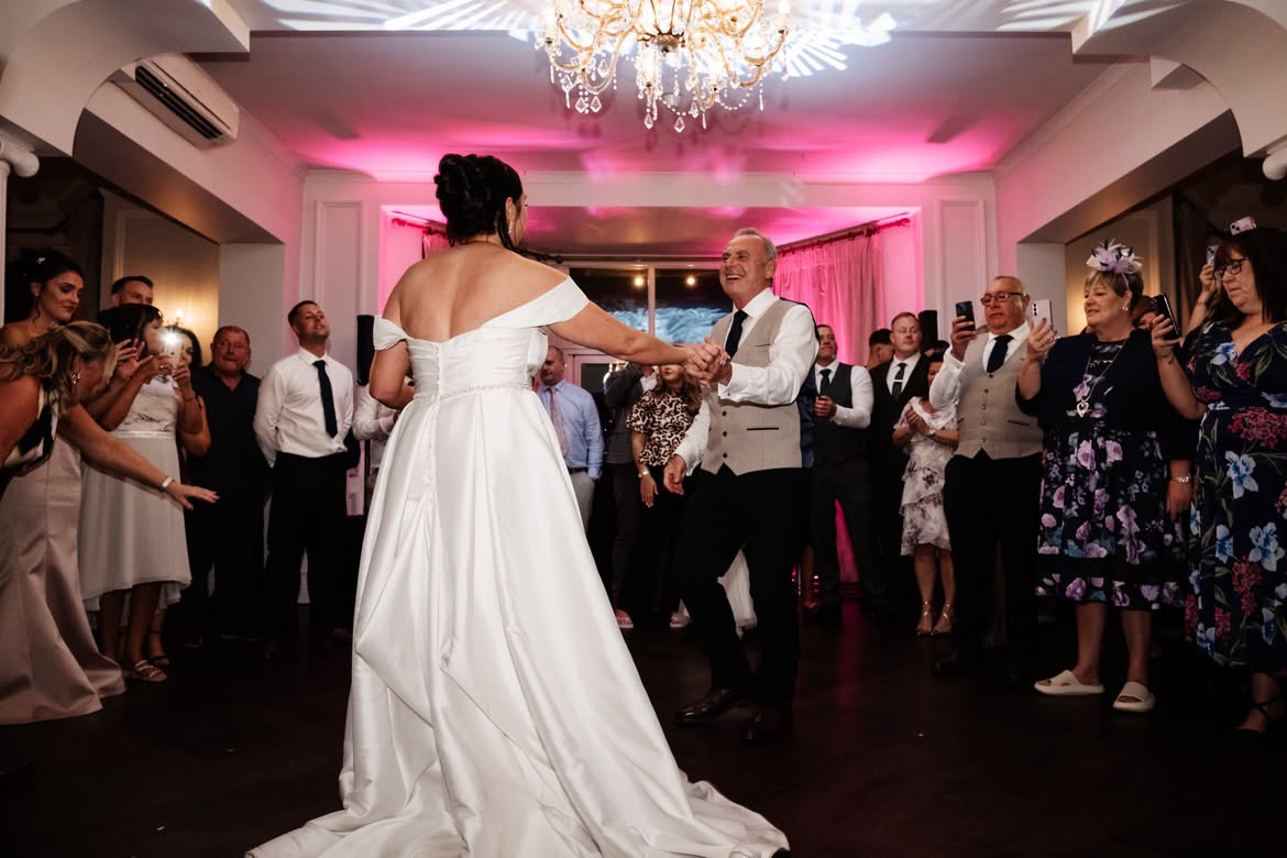 A first dance surrounded by guests filming on their phones