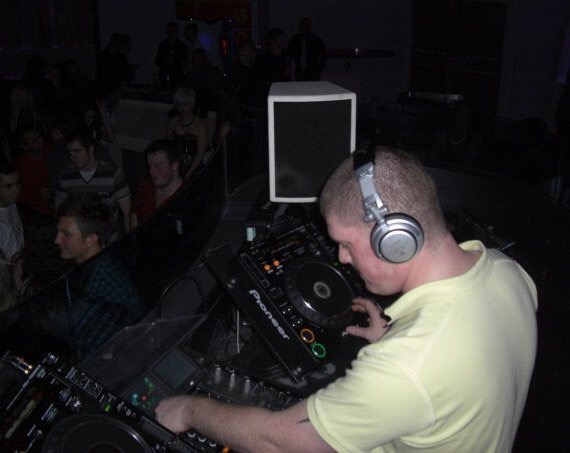 Jon at the decks in a club
