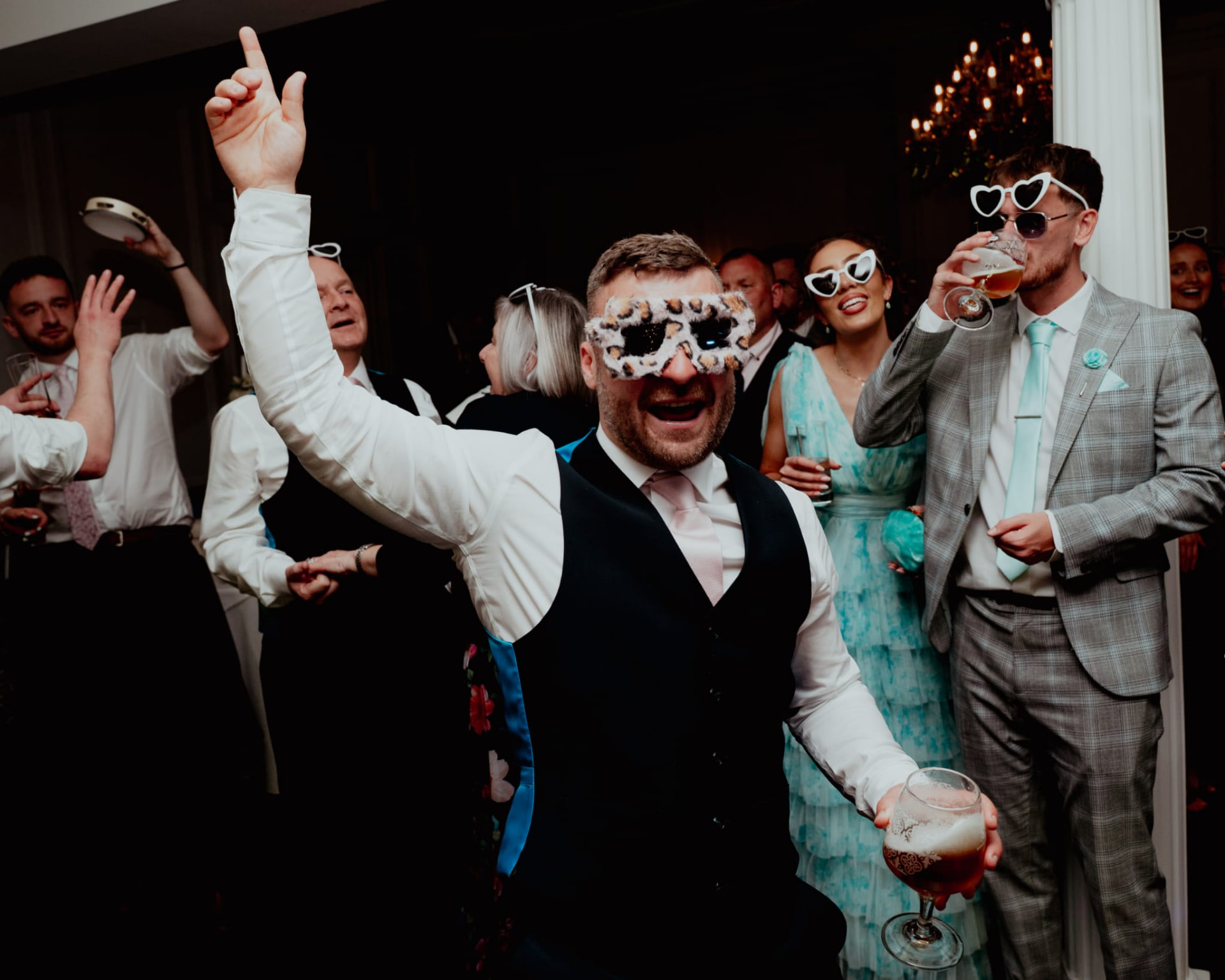 Guests dancing on the dancefloor in novelty sunglasses